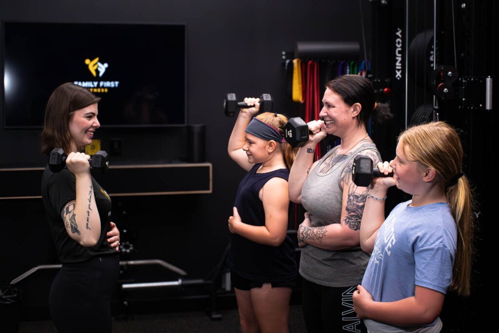 Female Personal Trainer training a family