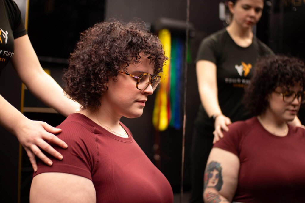 personal trainer helping prenatal client relax